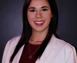 Headshot of Amanda Shoemaker in a white medical jacket